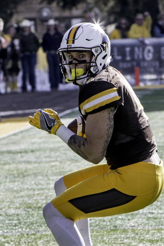 Tanner Gentry prepares to run after catching a pass from Josh Allen early in the 1st quarter. Photo Credit: Pete Arnold