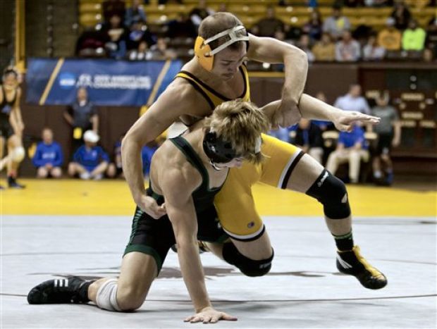 Cowboy wrestler Tyler Cox faces off with Utah Valley State wrestler Val Rauser during the WWC tournament in Laramie. Cox will look to capture All-American status again this season. (Photo courtesy of Jeremy Martin / Laramie Boomerang)