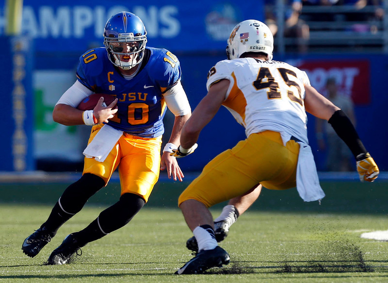 San Jose State Spartan quarterback David Fales is on a rush and stopped by Wyoming linebacker Luke Wacha on Saturday. San Jose State went on to win 51-44. (Karl Mondon/Bay Area News Group)