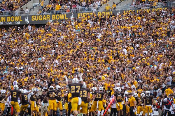 Wyoming celebrates a blocked punt in front of a packed War Memorial Stadium last Saturday. 