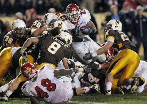 The Wyoming Cowboy defense, led by Chris Prosinski (24) and Mitch Unrein (96) stop Fresno State running back Ryan Mathews at the one yard line to seal up a New Mexico Bowl win in 2009. They will now be teammates for the Chicago Bears. (Photo via media.fresnobee.com)
